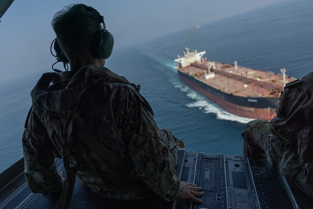 Adm. Brad Cooper, commander of U.S. Central Command, observes a commercial vessel transiting the Strait of Hormuz from the open ramp of a U.S. Army CH-47 Chinook, Oct. 25, 2026.